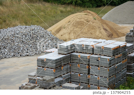 Construction Supply Yard With Sand Gravel And Concrete Paving Block Pallets. Construction Supply Yard With Sand Gravel And Concrete Paving Block Pallets. 137904255
