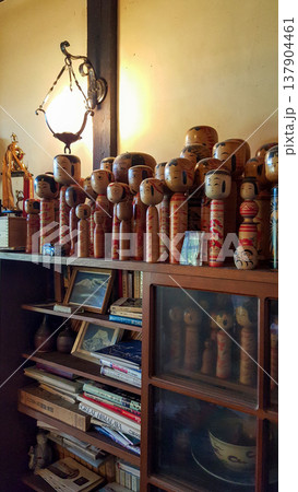 Photo of a collection of vintage kokeshi dolls in a traditional Japanese home 137904461