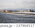 The stunning coastline of a Kuril Islands bay shines at sunset on a sunny winter day. 137904517