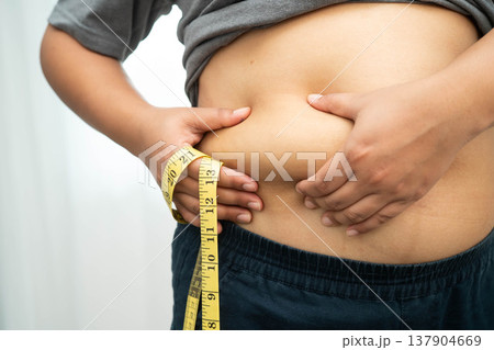 Asian woman with fat belly big size overweight and obesity with measure tape. Asian woman with fat belly big size overweight and obesity with measure tape. 137904669