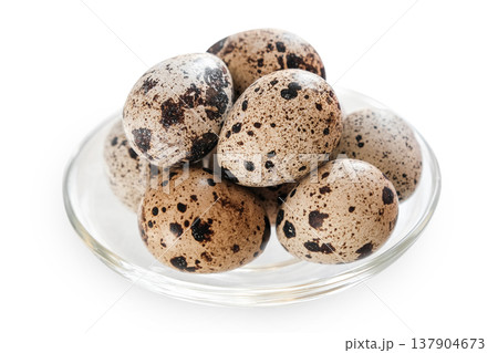 Quail eggs in glass bowl isolated on white background. Easter holiday concept, spring celebration 137904673