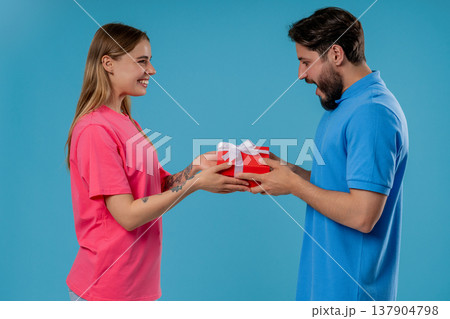 Young Woman Gives Gift Box To Husband Or Boyfriend. Surprise, Unexpected Present 137904798