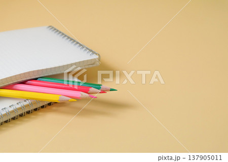 Colored pencils on book note ready for work. Colored pencils on book note ready for work. 137905011