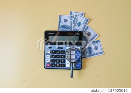 Calculator with magnifying glass,business theme. Calculator with magnifying glass,business theme. 137905012