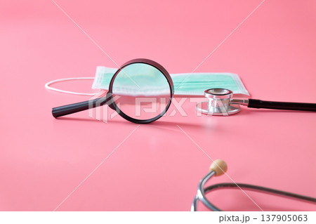 Stethoscope with mask on color background. 137905063