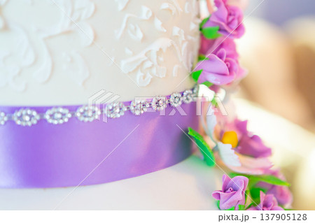 wedding cake decoration. beautiful wedding cake with purple orchids. cake in violet tones wedding cake decoration. beautiful wedding cake with purple orchids. cake in violet tones 137905128