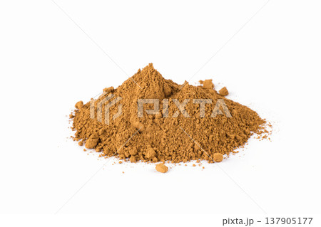 Golden Turmeric Powder Piled on a White Surface for Culinary Use and Health Benefits 137905177