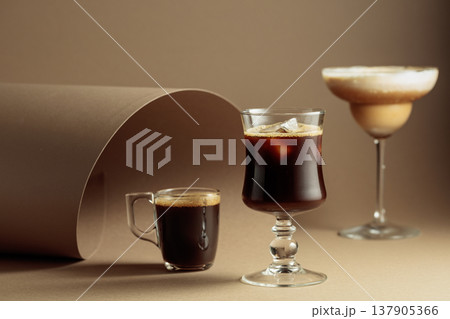 Black coffee and iced coffee cocktails on a beige background. Black coffee and iced coffee cocktails on a beige background. 137905366