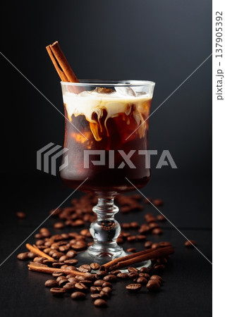 Iced coffee with cream on a black background. Iced coffee with cream on a black background. 137905392