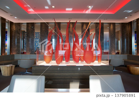 Frankfurt, Germany, 03 November 2017: Glass art installation of flames in a frequent flyer lounge Frankfurt, Germany, 03 November 2017: Glass art installation of flames in a frequent flyer lounge 137905891