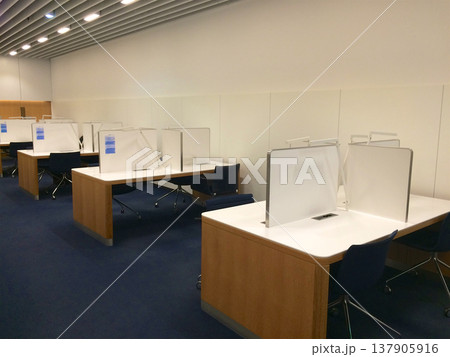 Frankfurt, Germany, 02 September 2017: Bright wooden work desks in a frequent flyer lounge Frankfurt, Germany, 02 September 2017: Bright wooden work desks in a frequent flyer lounge 137905916