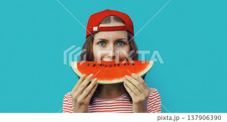 Summer portrait of happy young woman eating fresh slice of watermelon on blue background Summer portrait of happy young woman eating fresh slice of watermelon on blue background 137906390