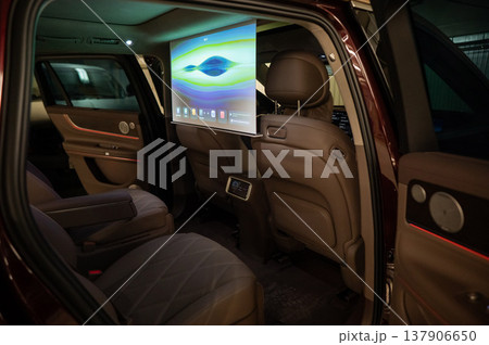 A projector opens in the car's interior for passengers to watch movies. 137906650