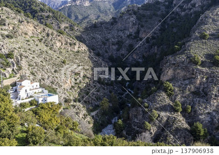 Stunning view of the Frigiliana valley with hills and houses under bright daylight in southern Spain Stunning view of the Frigiliana valley with hills and houses under bright daylight in southern Spain 137906938