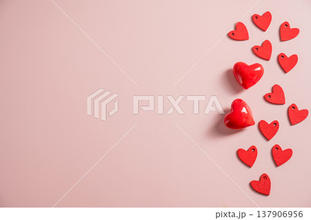 Valentine Day background with red hearts over pink background. St. Valentine's Day love concept, flat lay with copy space Valentine Day background with red hearts over pink background. St. Valentine's Day love concept, flat lay with copy space 137906956