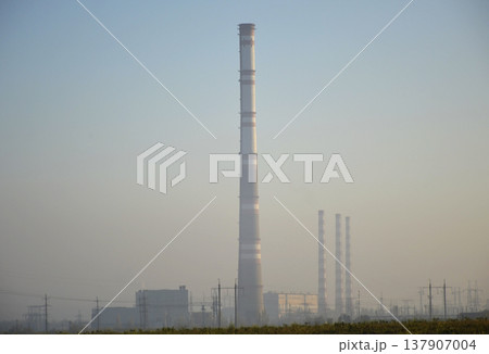 power plant in the rays of the sun at dawn 137907004