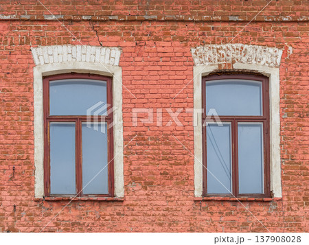 Two windows of the old mansion 19 century with brown bricks wall Two windows of the old mansion 19 century with brown bricks wall 137908028