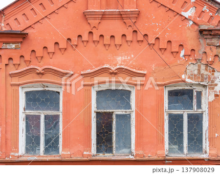 Three windows of the old mansion 19 century with brown bricks wall Three windows of the old mansion 19 century with brown bricks wall 137908029
