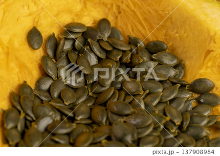 orange pumpkin seeds without husks, sliced pumpkin with baking pulp and healthy and nutritious seeds orange pumpkin seeds without husks, sliced pumpkin with baking pulp and healthy and nutritious seeds 137908984