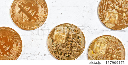 Golden commemorative btc - bitcoin cryptocurrency - coins scattered on white stone board, closeup detail from above 137909173