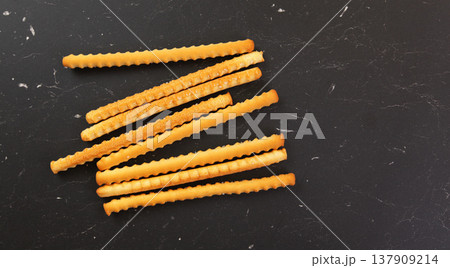Grissini, also known as breadsticks on black marble like table, view from above Grissini, also known as breadsticks on black marble like table, view from above 137909214