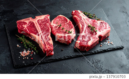T-bone steaks against a dark backdrop 137910703