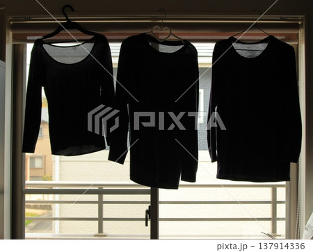 乾かない服を部屋干しする 137914336