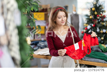 Woman choosing red panties before the new year 137914776