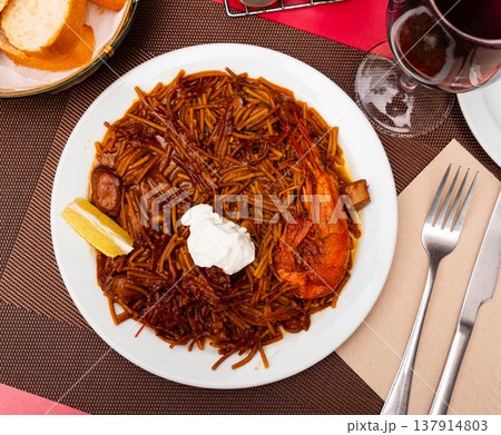Fideua with seafood served on platter 137914803