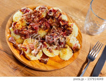 Fried pigs ear with red pepper and potatoes at plate Fried pigs ear with red pepper and potatoes at plate 137914849