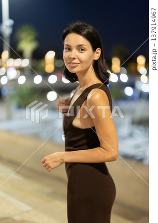 At night, smiling girl walks around old city district Barceloneta, in vicinage of Passeig Nou 137914967