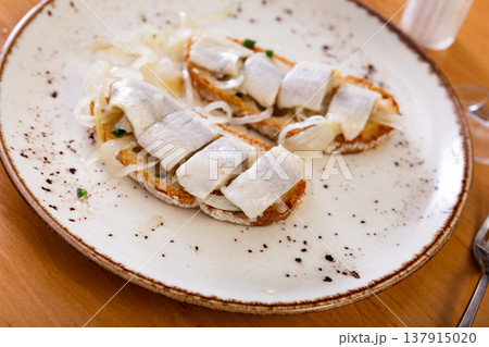 Marinated herring and onion sandwich served on plate 137915020