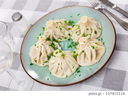 There is portion of khinkali on plate - national Georgian dish made of dough and meat There is portion of khinkali on plate - national Georgian dish made of dough and meat 137915119