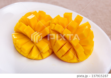 Deliciously served fresh mangoes diced and laid out on plate 137915287
