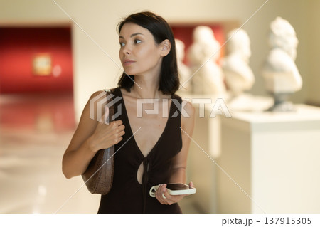 Young woman at a sculpture exhibition 137915305