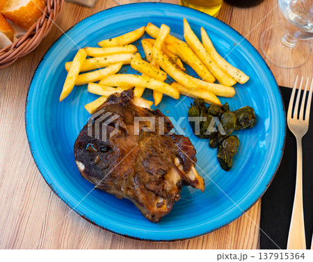 Baked pork knuckle and peppers with French fries 137915364