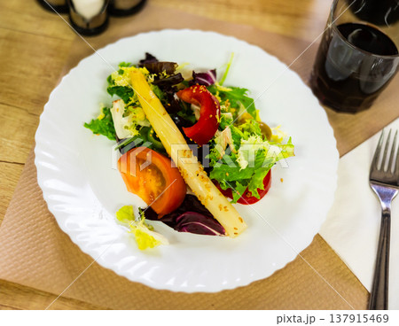 Traditional Spanish mixed salad, made from corn, tomato, lettuce, olives, asparagus, bell peppers Traditional Spanish mixed salad, made from corn, tomato, lettuce, olives, asparagus, bell peppers 137915469