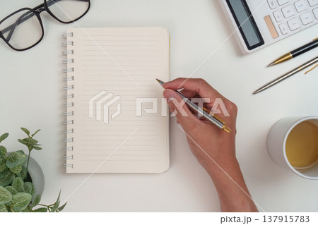 Minimalist workspace with notebook and pen Minimalist workspace with notebook and pen 137915783