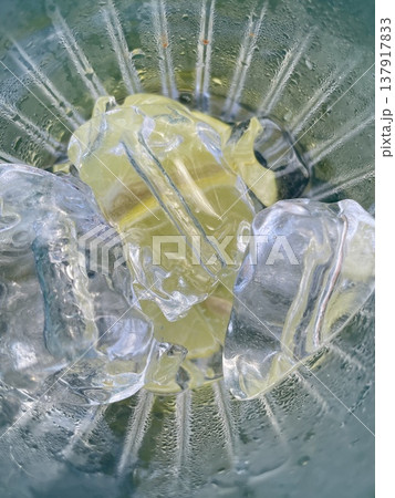 Refreshing Lemon Piece Topped With Ice Crystals And Shimmering Moisture On Vibrant Background 137917833