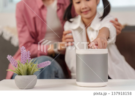 Child interacting with a smart speaker Child interacting with a smart speaker 137918158