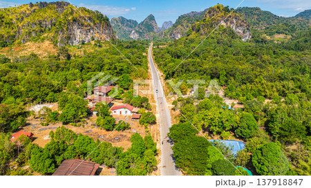 Dramatic Limestone Peaks Over Verdant Countryside in Laos Dramatic Limestone Peaks Over Verdant Countryside in Laos 137918847