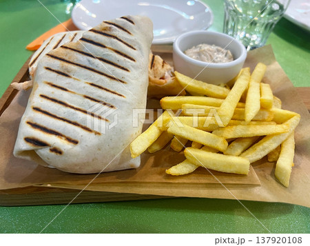 Shawarma with tartar sauce and French fries 137920108