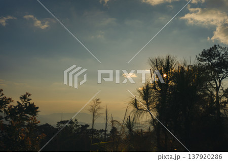 sunset with moving of cloud and clear sky and layer of mountain sunset with moving of cloud and clear sky and layer of mountain 137920286