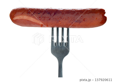 Appetizing sausage on a fork, isolated on white background 137920611