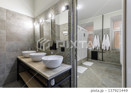 Spacious Modern Hostel Shared Bathroom with Multiple Vessel Sinks Spacious Modern Hostel Shared Bathroom with Multiple Vessel Sinks 137921449