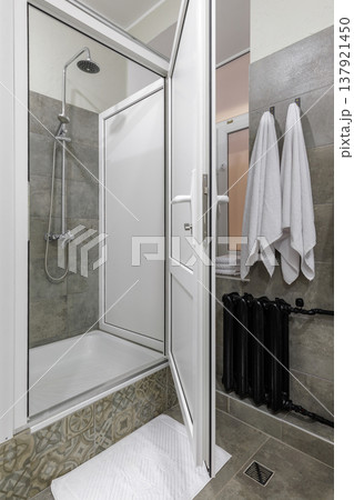 Modern Shared Hostel Shower Area with White Towels and Black Radiator Modern Shared Hostel Shower Area with White Towels and Black Radiator 137921450