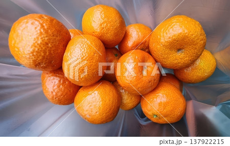 Fresh Ripe Tangerines and Mandarins in a Translucent Plastic Bag 137922215