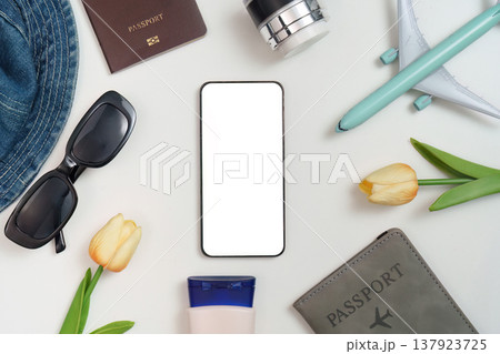 Travel essentials with smartphone on white background Travel essentials with smartphone on white background 137923725