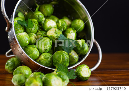 fresh brussels sprouts spilling from colander rustic kitchen style fresh brussels sprouts spilling from colander rustic kitchen style 137923740