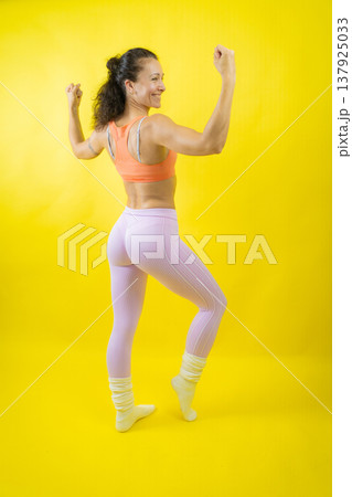 Strong woman flexing muscles showing fitness progress Strong woman flexing muscles showing fitness progress 137925033